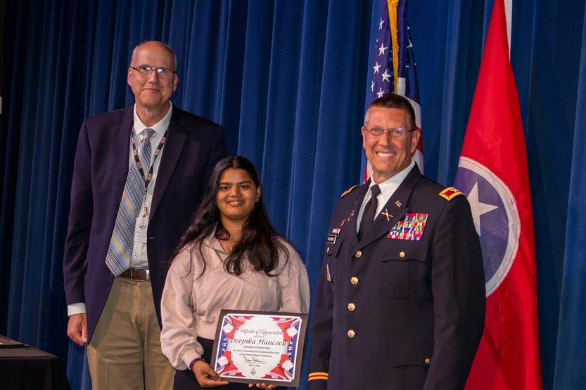 A student is honored for serving in the US Armed Forces after high school